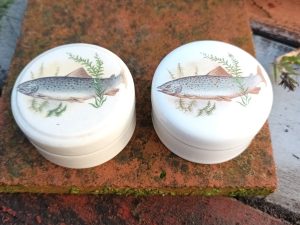 Two small jars of Patum Peperium 'The Gentleman's Relish' with fish on them.