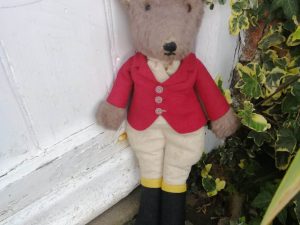 Super Example of Mr Fox dressed as Huntsman, wearing a red jacket and boots.