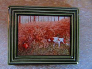 A picture of a dog in the woods.